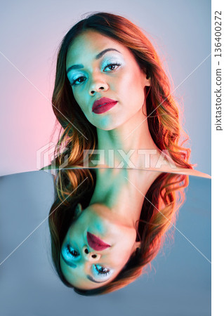 Art, mirror and beauty, portrait of woman on studio background with neon light and makeup. Fashion, skin and future aesthetic, face of girl or model in creative reflection with cosmetics and color. Art, mirror and beauty, portrait of woman on studio background with neon light and makeup. Fashion, skin and future aesthetic, face of girl or model in creative reflection with cosmetics and color. 136400272