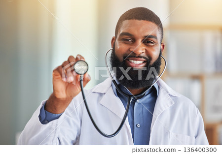 Doctor, man and portrait with stethoscope for heartbeat, healthcare services and cardiology. Face of happy medical african worker with tool to listen, check breathing and lungs for test in hospital Doctor, man and portrait with stethoscope for heartbeat, healthcare services and cardiology. Face of happy medical african worker with tool to listen, check breathing and lungs for test in hospital 136400300