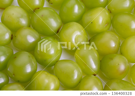 Macro image showcasing vibrant grapes creating organic repeating pattern, Highly detailed macro shot of fresh green grapes with natural highlights and smooth skins Macro image showcasing vibrant grapes creating organic repeating pattern, Highly detailed macro shot of fresh green grapes with natural highlights and smooth skins 136400328
