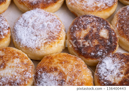 Mini cheese bites, Bright display of miniature cheese cakes dusted with sugar, Closeup of charming small cheese bites sprinkled with sweet powdered sugar for breakfast Mini cheese bites, Bright display of miniature cheese cakes dusted with sugar, Closeup of charming small cheese bites sprinkled with sweet powdered sugar for breakfast 136400443