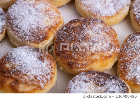 Elegant dessert display, Plated syrniki with sugar in sophisticated artisanal presentation, Closeup shot showcasing artisanal syrniki with sugar in elegant and menuworthy display 136400480