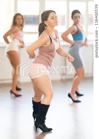 Young female dancer in heels practicing jazz-funk in studio 136400539