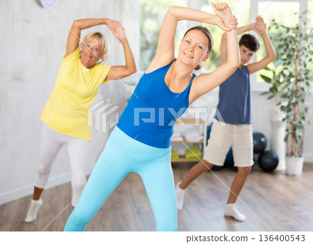 Group of people in gym incendiary dance doing fitness Group of people in gym incendiary dance doing fitness 136400543