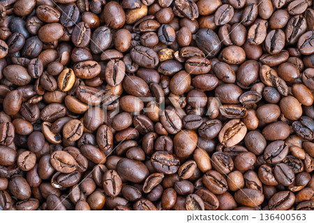 Roasted coffee with natural shine, Sustainable farm sourced beans with uneven color pattern, Handpicked single origin coffee beans showcasing natural variation and rich aroma Roasted coffee with natural shine, Sustainable farm sourced beans with uneven color pattern, Handpicked single origin coffee beans showcasing natural variation and rich aroma 136400563