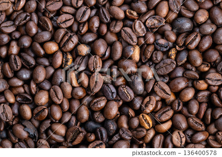 Dark roasted beans shine brightly, Glossy evening coffee beans arranged artfully, Detailed view of shiny roasted Arabica beans highlighting surface features and aroma Dark roasted beans shine brightly, Glossy evening coffee beans arranged artfully, Detailed view of shiny roasted Arabica beans highlighting surface features and aroma 136400578