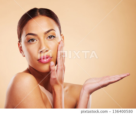 Face, skincare mockup or natural woman in studio isolated on brown background for promotion. Facial, beauty advertising or hand of girl portrait with glow, self love or luxury cosmetics showing space Face, skincare mockup or natural woman in studio isolated on brown background for promotion. Facial, beauty advertising or hand of girl portrait with glow, self love or luxury cosmetics showing space 136400580