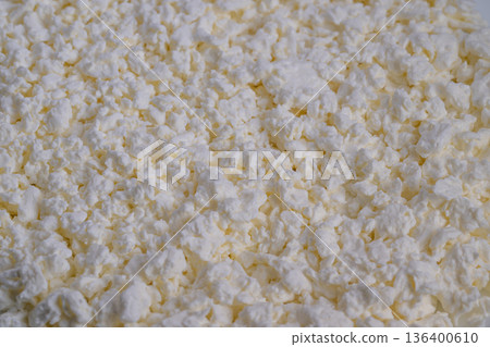 Closeup curds in bowl, breakfast prep mood, creamy white curd texture contrasted with white surface, suggestion of healthy morning recipe and simple plating 136400610