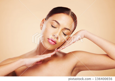 Face, calm or woman with natural beauty in studio isolated on brown background for wellness or glow. Skin care shine, hands or zen Brazilian girl model with self love, eyes closed or facial cosmetics 136400656
