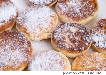 Delicious breakfast treat, Homestyle cottage cheese pancakes with powdered sugar, Inviting family breakfast of soft cottage pancakes dusted with sugar and served with jam Delicious breakfast treat, Homestyle cottage cheese pancakes with powdered sugar, Inviting family breakfast of soft cottage pancakes dusted with sugar and served with jam 136400659