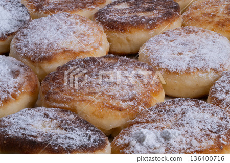 Pancakes with sugar, Sweet cottage cheese pancakes with golden crust and sugar dusting, Detailed closeup of fluffy pancakes with textured crumbs and caramelized edges Pancakes with sugar, Sweet cottage cheese pancakes with golden crust and sugar dusting, Detailed closeup of fluffy pancakes with textured crumbs and caramelized edges 136400716