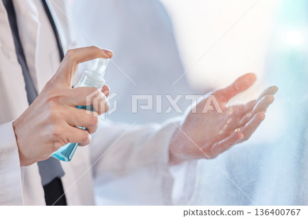 Sanitizer, cleaning and hands of doctor with protection from bacteria or hygiene against virus at the workplace. Disease, closeup and professional medical employee or healthcare worker for wellness Sanitizer, cleaning and hands of doctor with protection from bacteria or hygiene against virus at the workplace. Disease, closeup and professional medical employee or healthcare worker for wellness 136400767
