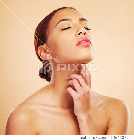 Beauty, skincare touch and woman with eyes closed in studio isolated on brown background. Face, makeup cosmetics and natural model touch neck after spa facial treatment for wellness and healthy skin 136400791