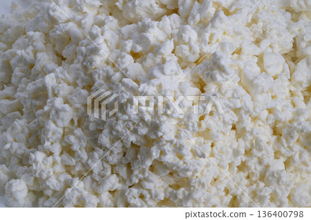 Fresh cottage cheese granules photographed closeup, soft creamy texture, artisan curds, natural dairy tones, rustic kitchen mood, ideal for food branding and recipe visuals Fresh cottage cheese granules photographed closeup, soft creamy texture, artisan curds, natural dairy tones, rustic kitchen mood, ideal for food branding and recipe visuals 136400798