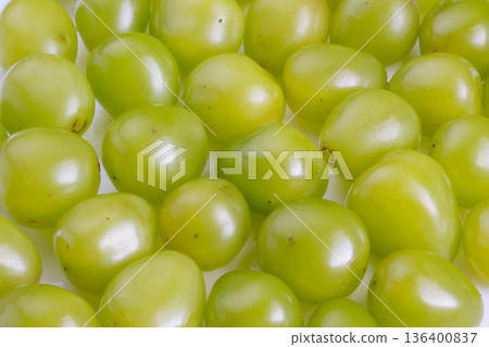 Colorful clusters with tiny stems, Bright green grapes arranged for sale, Lively arrangement of green grapes with subtle reflections emphasizing ripeness and vibrancy 136400837