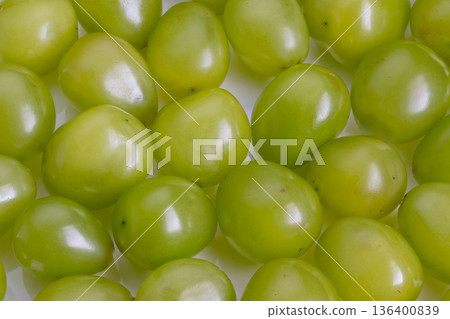 Sweet green grapes ready for snacking, clustered smooth spheres with light sheen and vivid color, conveys wholesome snack idea, perfect for picnic, diet or wellness imagery Sweet green grapes ready for snacking, clustered smooth spheres with light sheen and vivid color, conveys wholesome snack idea, perfect for picnic, diet or wellness imagery 136400839