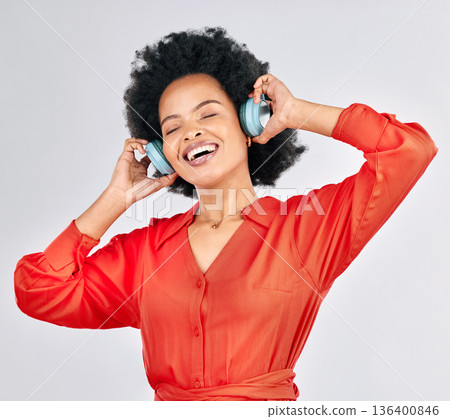 Black woman, headphones and happy music in studio for podcast subscription on white background. Face, freedom and female model smile while listening to audio, streaming sound or hearing song on radio Black woman, headphones and happy music in studio for podcast subscription on white background. Face, freedom and female model smile while listening to audio, streaming sound or hearing song on radio 136400846