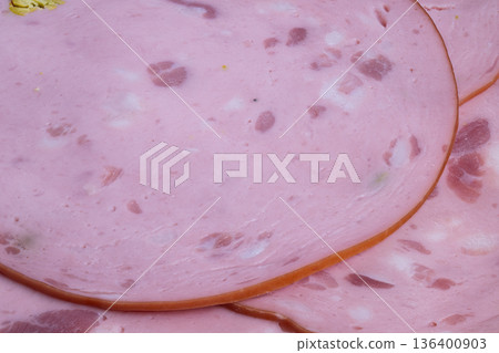 Visual of sliced meat and nuts, Presentation of sausage slices with pistachios on shelf, Colorful retail setup featuring sliced sausage with pistachios and vibrant contrast 136400903