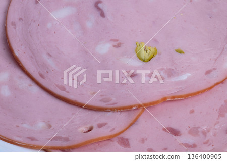 Thin layered delicacy, Overlapping mortadella slices with glossy edges and pistachios, Layers of cured mortadella with pistachio pieces evoke nostalgic vintage deli scene Thin layered delicacy, Overlapping mortadella slices with glossy edges and pistachios, Layers of cured mortadella with pistachio pieces evoke nostalgic vintage deli scene 136400905