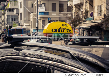 Tel Aviv, Israel, January 3, 2026 Taxis navigate the busy streets of downtown Tel Aviv, maintaining the city mobility and flow despite the ongoing regional conflict and heightened security tensions. Tel Aviv, Israel, January 3, 2026 Taxis navigate the busy streets of downtown Tel Aviv, maintaining the city mobility and flow despite the ongoing regional conflict and heightened security tensions. 136400939