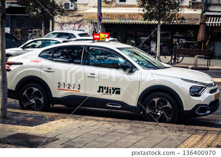 Tel Aviv, Israel, January 3, 2026 Taxis navigate the busy streets of downtown Tel Aviv, maintaining the city mobility and flow despite the ongoing regional conflict and heightened security tensions. Tel Aviv, Israel, January 3, 2026 Taxis navigate the busy streets of downtown Tel Aviv, maintaining the city mobility and flow despite the ongoing regional conflict and heightened security tensions. 136400970