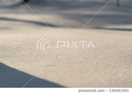 Unspoiled snow patch illuminated by sunrise with delicate crystalline patterns, Immaculate snow covering landscape reflecting morning sunlight and creating gentle shadowed textures Unspoiled snow patch illuminated by sunrise with delicate crystalline patterns, Immaculate snow covering landscape reflecting morning sunlight and creating gentle shadowed textures 136401091