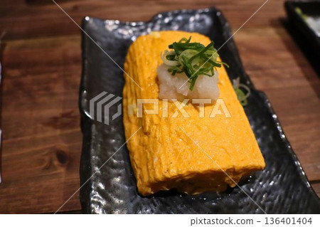 蓬鬆的捲蛋餅盛放在黑色盤子裡 136401404