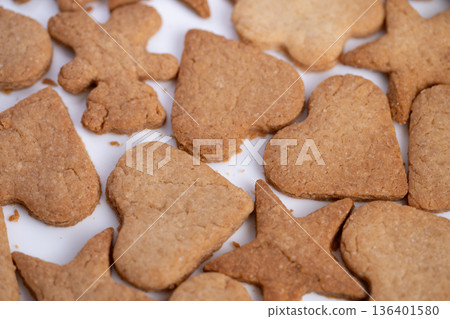Closeup teddy heart cookies arranged tightly on white, warm ginger spice tones and crumbly surfaces, festive family baking vibe perfect for holiday gift and seasonal storytelling 136401580
