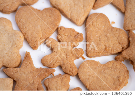 Holidaythemed sweet treats evoke nostalgia, Decorative gingerbread cookies shaped like hearts and stars suggest festive holiday celebration and cheerful childhood moments Holidaythemed sweet treats evoke nostalgia, Decorative gingerbread cookies shaped like hearts and stars suggest festive holiday celebration and cheerful childhood moments 136401590