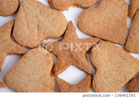 Decorative starshaped cookies on bright background evoke warmth, Circular pattern of decorated cookies with warm colors emphasizes seasonal family joyful moments Decorative starshaped cookies on bright background evoke warmth, Circular pattern of decorated cookies with warm colors emphasizes seasonal family joyful moments 136401591