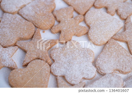 Colorful baked cookie varieties, Selection of sweet shaped cookies with powdered sugar icing, An array of artistic cookies in diverse shapes garnished with sugary coatings 136401607
