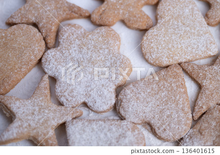 Festive sweet treats, Gourmet Christmas confections shaped like bells and flowers, Assorted powdered sugar cookies designed to enhance holiday celebration tables with charm 136401615