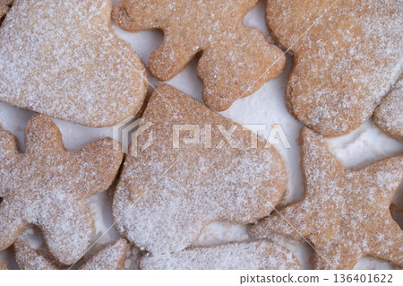 Variety of powdered sugar dusted cookies share cozy holiday feeling, Selection of imperfect handmade cookies covered in powdered sugar captures holiday nostalgia warmth 136401622