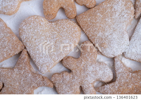 Artisan bakery style heart cookie highlighted by natural daylight, Textured heartshaped biscuit decorated with powdered sugar and illuminated by soft natural lighting 136401623