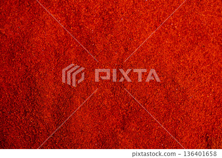 Market paprika heat and aroma captured in glowing emberlike red powder, suggesting nourishing healthy plantbased flavor for vegan cooking and spice market displays 136401658