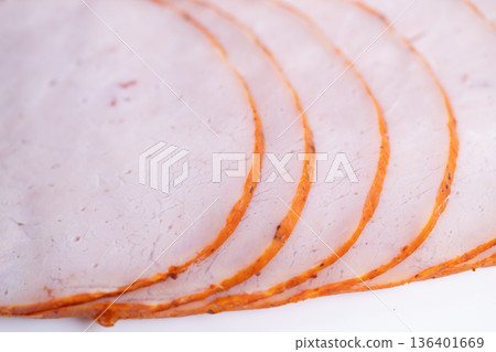 Deli production sliced ham ready for packing, consistent portioning and seasoned rim emphasize commercial processing standards, useful for supplier catalogs and BB food imagery Deli production sliced ham ready for packing, consistent portioning and seasoned rim emphasize commercial processing standards, useful for supplier catalogs and BB food imagery 136401669