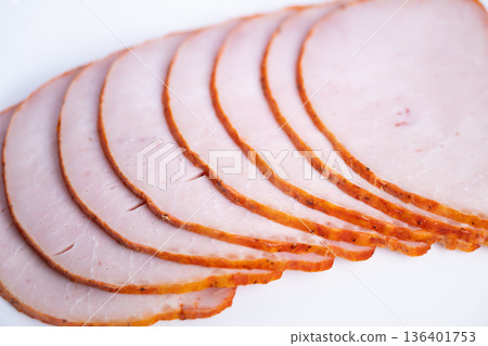 Ham slices arranged for presentation. Slices of ham neatly arranged for product display. Perfectly aligned ham pieces prepared for packaging and ecommerce product images 136401753