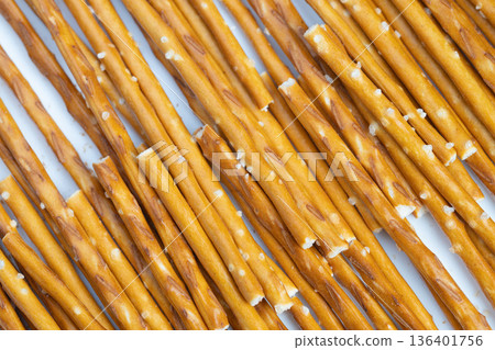 Closeup of shattered pretzels and salt. High resolution image of broken pretzar sticks with coarse salt. Macro shot revealing fractured pretzels with coarse salt and textures Closeup of shattered pretzels and salt. High resolution image of broken pretzar sticks with coarse salt. Macro shot revealing fractured pretzels with coarse salt and textures 136401756