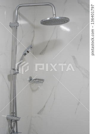 Modern chrome shower system in bright marble bathroom interior design 136401797