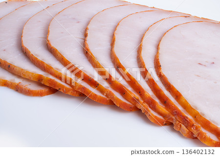 Meat presentation. Casual outdoor dining featuring rustic smoked turkey slices. Natural seasoned smoked turkey presented on wooden board for outdoor picnics 136402132