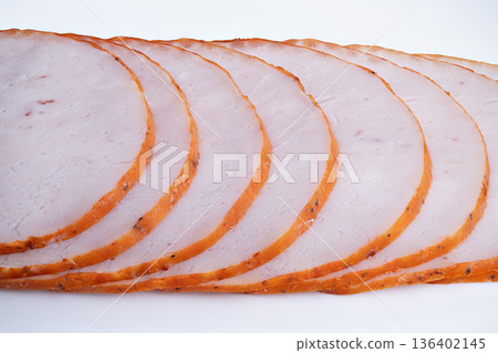 Nutritional roast slices under neutral lighting. Presentation of delicately sliced roast meat highlighting macrofriendly protein and neutral studio illumination 136402145
