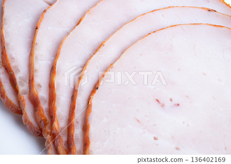 Refined arrangement of sliced roast on white background. Artistically arranged sliced roast for upscale dining ambiance with subtle decorative elements and sleek finishing 136402169