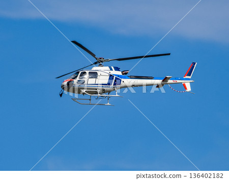 A helicopter flying in the blue sky A helicopter flying in the blue sky 136402182