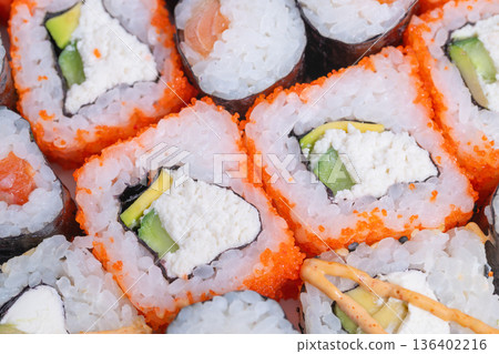 Eventfriendly sushi options with diverse rolls and lively toppings. Elegant selection of fingersized sushi pieces with colorful toppings for special celebrations Eventfriendly sushi options with diverse rolls and lively toppings. Elegant selection of fingersized sushi pieces with colorful toppings for special celebrations 136402216