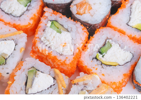 Nutritious sushi meal. Fresh vegetable and protein balance. Healthy sushi with avocado and cucumber focus. Light rice portion combined with fresh vegetables and protein Nutritious sushi meal. Fresh vegetable and protein balance. Healthy sushi with avocado and cucumber focus. Light rice portion combined with fresh vegetables and protein 136402221