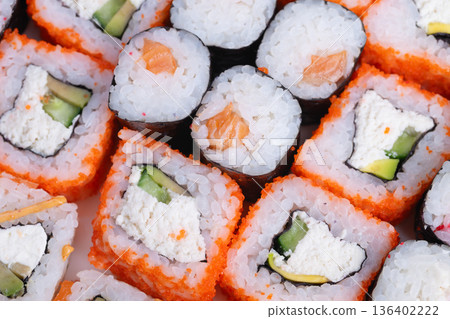 Prepared sushi ready for delivery. Freshly prepared sushi arranged for swift takeaway. Highquality sushi portions packaged efficiently for fast service and delivery 136402222