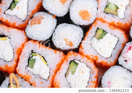 Professional sushi meal. Fresh and portable sushi lunch. Quick service for busy office professionals. Convenient sushi carries wrapped with avocado slices for workday meals 136402223