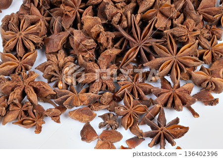 Vivid spice scent. Showcasing rich fragrance and textured pods for health uses. Highresolution image emphasizing natural aroma of star anise pods suitable for therapies 136402396