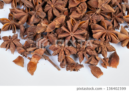 Pile of star anise used for seasoning, earthy flavor profile with artisan appeal, suggested pairings with meats and desserts, culinary concept shot for menus and recipe visuals Pile of star anise used for seasoning, earthy flavor profile with artisan appeal, suggested pairings with meats and desserts, culinary concept shot for menus and recipe visuals 136402399