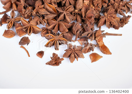 Star anise pattern. Radial arrangement of star anise with textured surface. Highresolution photograph capturing intricate ridges and seeds of star anise for visual design 136402400