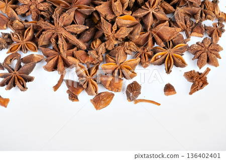 Loose star anise near tea setup, warm aromatic notes and dried pods ready for infusion, wellness and immunity concept for tea brands and herbal content, inviting kitchen atmosphere 136402401